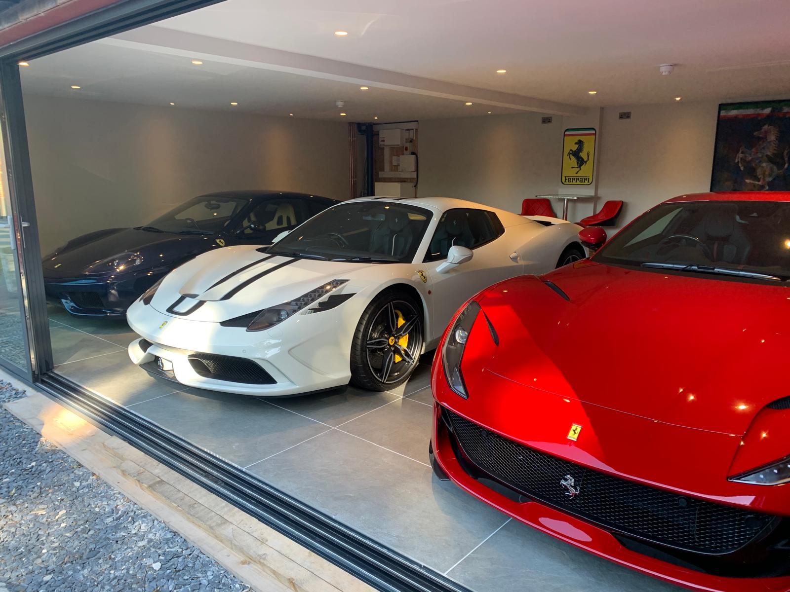 Private garage finished in large-format grey porcelain tile flooring